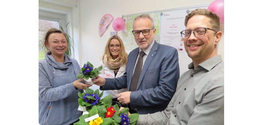 Bürgermeister Jörg Schmidt (2.v.r.), Beigeordneter Swen Christian (r.) und Gleichstellungsbeauftragte Tamara Schneider (2.v.l.) überreichen den Rathaus-Mitarbeiterinnen ein blumiges „Dankeschön“. 